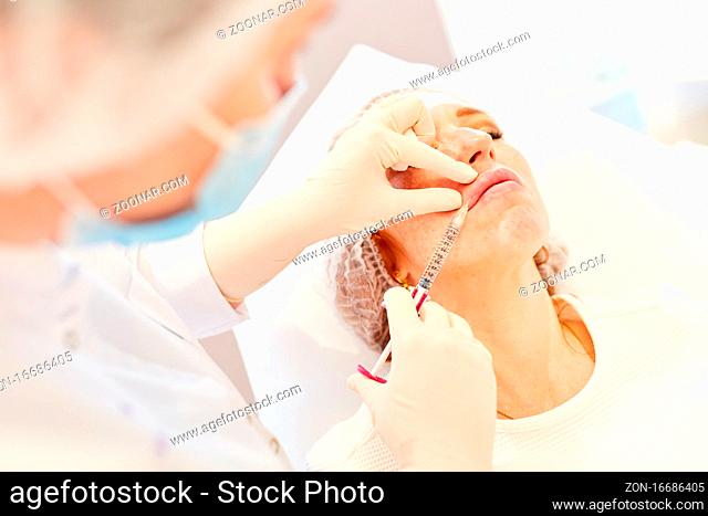 Hautarzt beim Lippen aufspritzen für Lippenvergrößerung mit Hyaluronsäure beim Facharzt