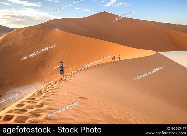 Hikers Hiking on Sand Dunes in Sossusvlei , Namib-Naukluft National Park , Namibia