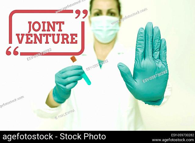 Text caption presenting Joint Venture, Word for business partnership invested jointly by two or more companies Studying Newly Discovered Medication Analyzing...