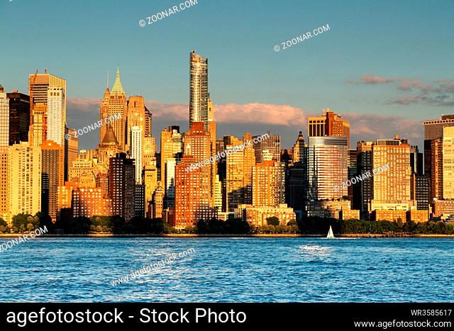 New York City / USA - JUL 18 2018: Buildings facade and aparmetns in Midtown Manhattan at sunset view from Hudson riverside