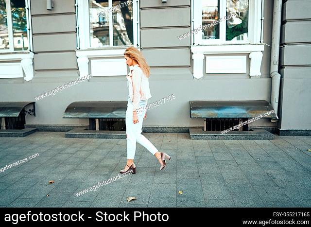 Girl posing on city street at camera