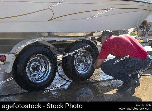 Evanston, Wyoming - An employee of the Wyoming Game & Fish Department inspects and decontaminates watercraft at a mandatory inspection station along the Utah...