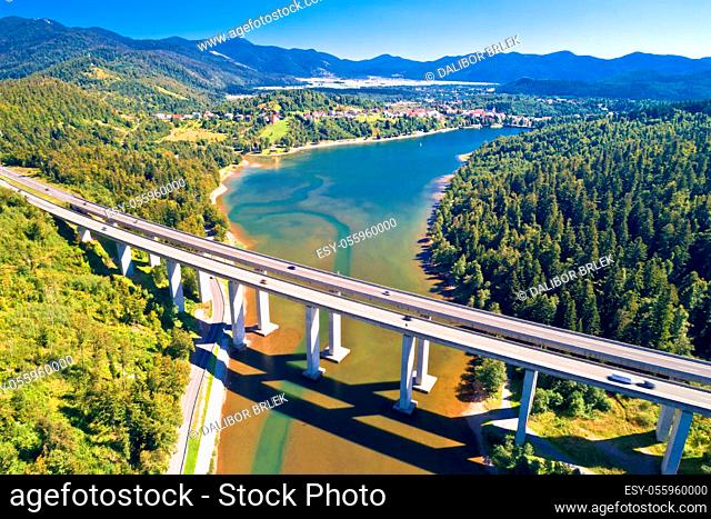 Viaduct Bajer above idyllic lake and town of Fuzine aerial view, Scenic highway A6 in Gorski Kotar region of Croatia