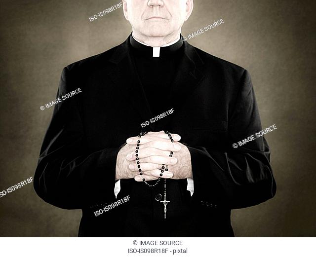 A priest holding prayer beads