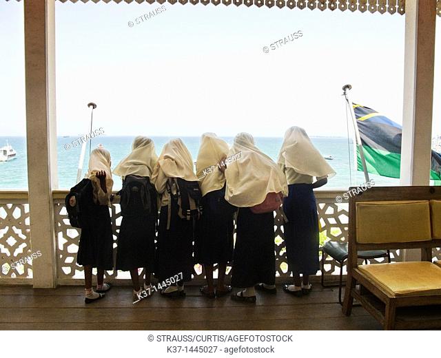 School girls looking at view from Palace Museum, Stone Town, Zanzibar