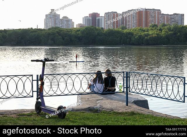 RUSSIA, MOSCOW - MAY 18, 2023: People sit by Moscow's Borisovo Ponds. On May 18, Moscow Mayor Sergei Sobyanin ordered to impose restrictions in Moscow's...