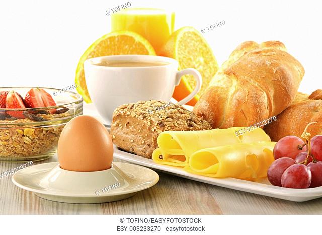 Breakfast with coffee, rolls, egg, orange juice, muesli and cheese