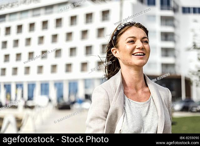 A portrait of a young confident woman walking in the city by marina