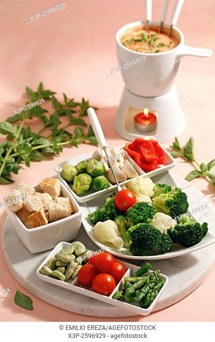 Cheese fondue with vegetables and oregano