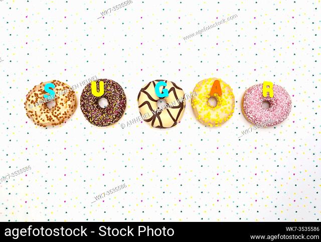 Various colored delicious donuts with festive star background Celebration concept. Top view space for text background party concept
