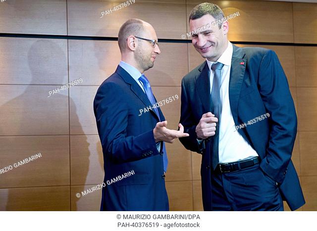 Representatives of the political opposition Vitali Klitschko (R) and Arseni Jazenjuk (L) talk to each other while waiting upon the arrival of German Foreign...