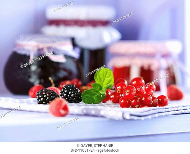 An arrangement of berries and jellies in jars
