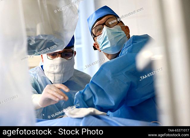 RUSSIA, IVANOVO - NOVEMBER 30, 2023: Yevgeny Varentsov (R), head of the urology department, performs a lithotripsy using thulium fibre laser at City Clinical...