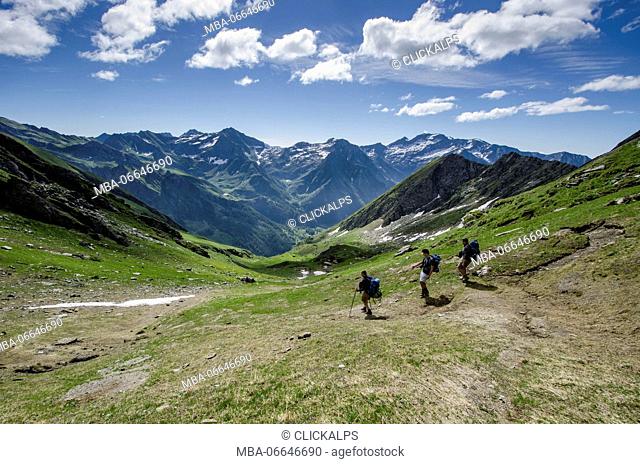 Hikers in descent in the valley (Val Soana, Gran Paradiso National Park, Piedmont, Italy)