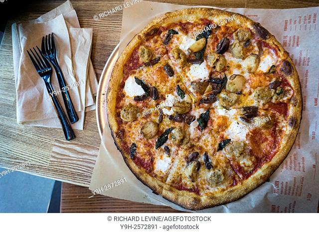 A custom made pizza for in-house dining at the newly opened Blaze Pizza franchise in Newark, NJ on Saturday, 23, 2015. Blaze constructs its pizzas in a Chipotle...