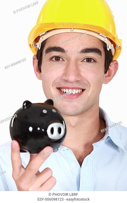 Builder holding piggy-bank