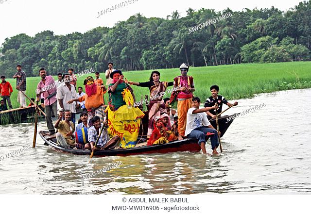 A group of people in colorful appearance entertain the audience with music and dance during the Boat race festival, in Manikganj, Bangladesh August 29