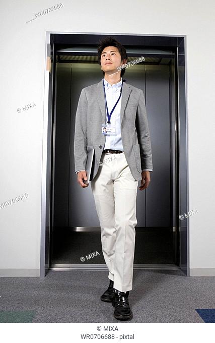 Businessman walking at elevator hall