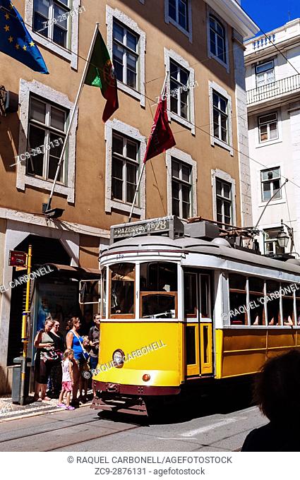 Tourists at a tram stop in front of a hotel, Lisbon, Portugal