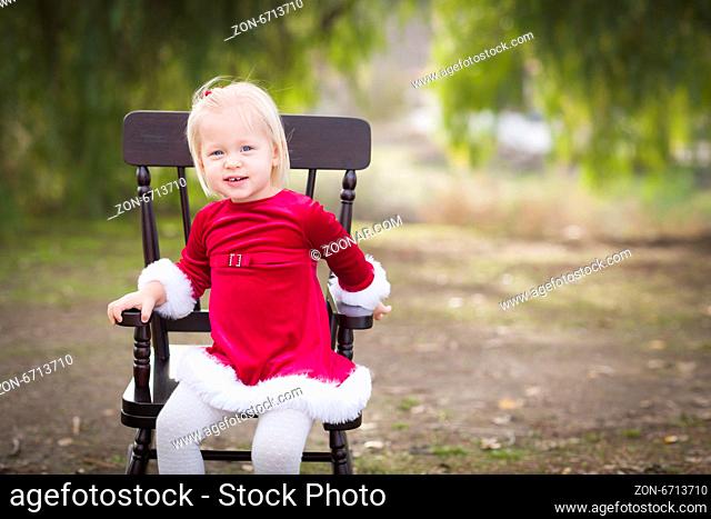 Adorable Little Girl Sitting in Her Rocking Chair Outside