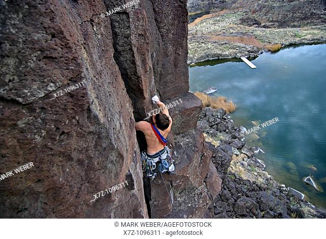 Man rock climbing a route called The Cutting Edge which is rated 5, 9 and located on The Tall Cliffs at Dierkes Lake Park in the Snake River Canyon near the...