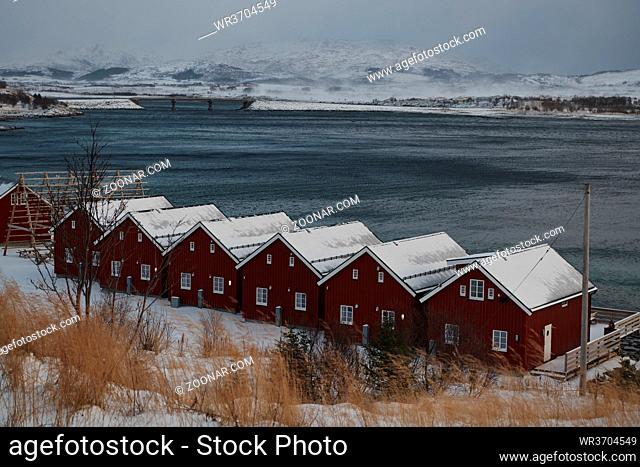 Traditional Norwegian fisherman's cabins and boats, on the island of Lofoten in northern Norway. Winter season bad weather