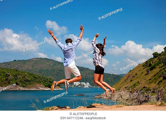 Young couple look at sea