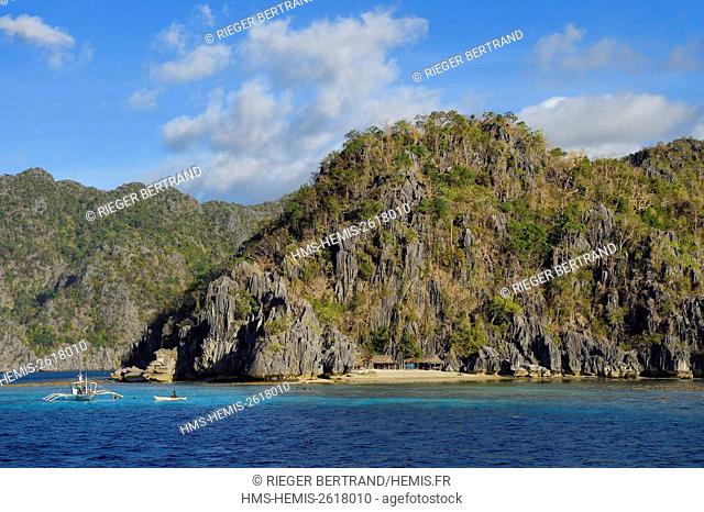 Philippines, Calamian Islands in northern Palawan, Coron Island Natural Biotic Area, Banul Beach under walls of limestone cliffs