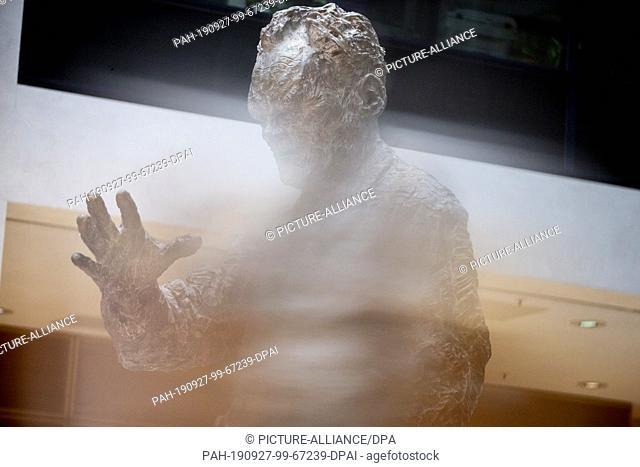 27 September 2019, Berlin: The Willy Brandt sculpture by the artist Rainer Fetting can be seen through a glass in the Willy Brandt House