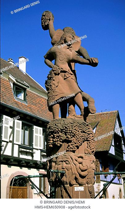 France, Haut Rhin, Kientzheim, fountain, sandstone statue, holding Vendangeurs and Alsatian grapes