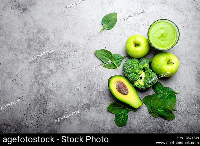 Ingredients for making green healthy smoothie with broccoli, apples, avocado, spinach, stone background. Clean eating, detox plan, diet, weight loss concept