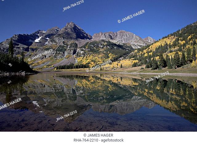 Maroon Bells reflected in Crater Lake with fall color, White River National Forest, Colorado, United States of America, North America