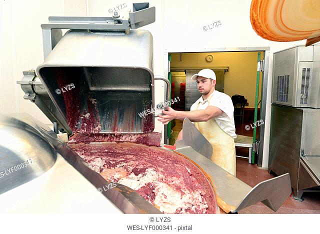 Man operating silent cutter in a butchery
