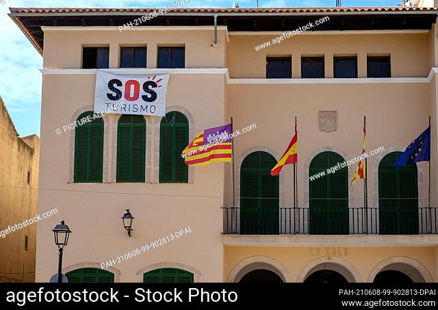 28 May 2021, Spain, Ses Salines: SOS Turismo is written on a poster in Ses Salines in the east of the island of Mallorca at the town hall of the city