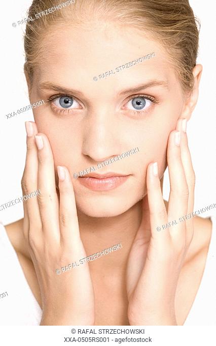 young woman massaging her face