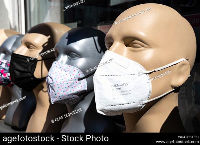 Berlin, Germany, Europe - Display and selection of various protective face masks against the coronavirus (Covid-19) on mannequin heads in front of a retail...