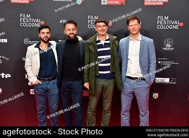 27 October 2021, North Rhine-Westphalia, Cologne: Yasin Islek, Eddy Cheaib, Stefan Job and Fynn Zinapold come to the screening of the film Westwall at the Film...