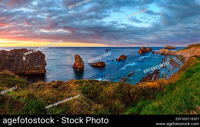 Sunset Arnia Beach (Spain, Atlantic Ocean) coastline landscape. Two shots stitch panorama