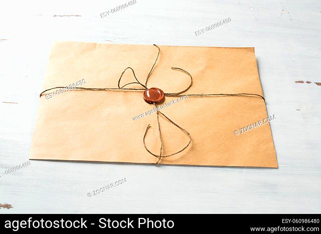 Old letter envelope with wax seal on wooden surface