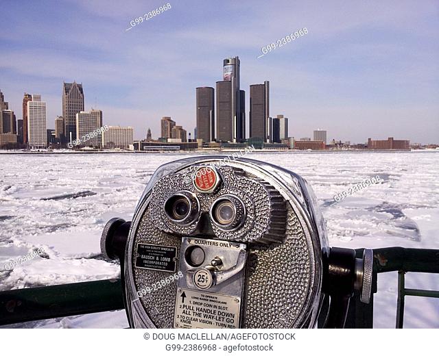 Coin operated high quality binoculars overlook the Detroit River and the Detroit skyline in winter from Windsor, Ontario, Canada