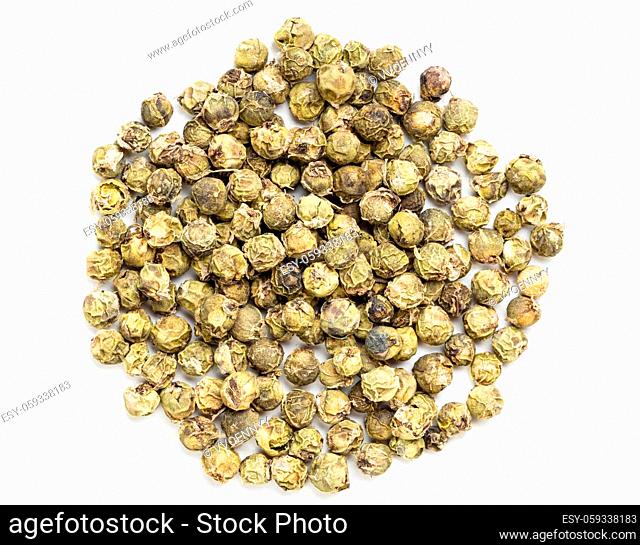 top view of pile of green pepper peppercorns on gray ceramic plate
