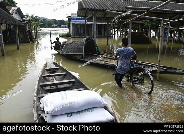 Villager uses a country boat to move across a flooded locality in Morigaon district of Assam, Monday, July 13, 2020