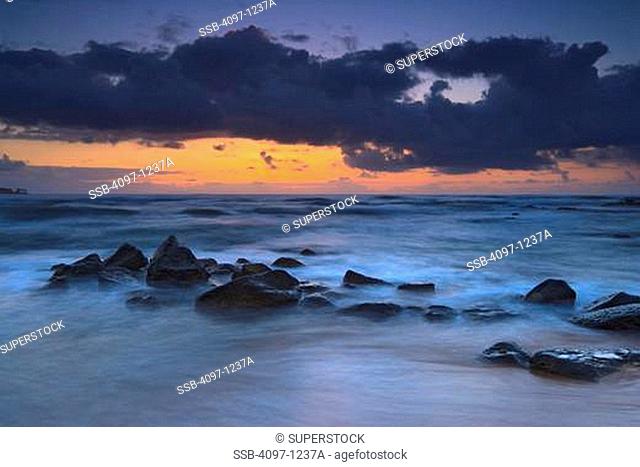 Rocks on the beach at sunrise, Coconut Coast, Kauai, Hawaii, USA