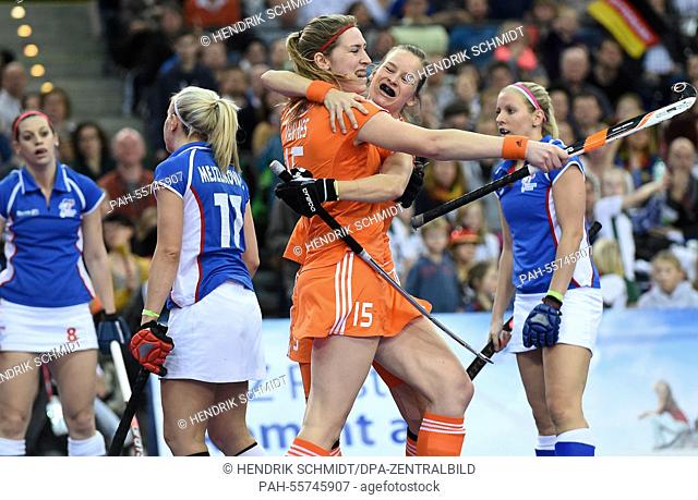 Netherlan's Pauline van Nes and Denise Admiraal (C, L) celebrate during the women's semifinal match Czech Republic vs Netherlands at the hockey world...
