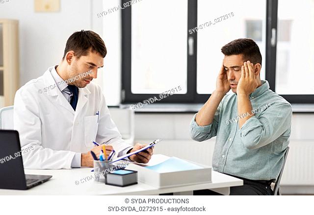 doctor and male patient having headache at clinic