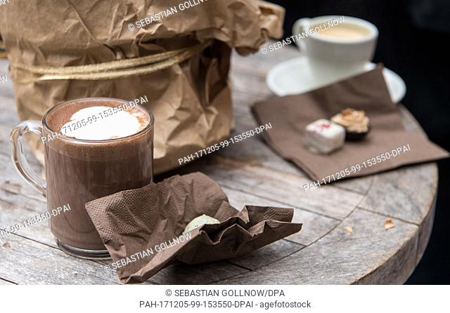 A glass full of hot chocolate stands on a table at the chocolate market ""chocolART"" during the first day of its opening in Tuebingen, Germany