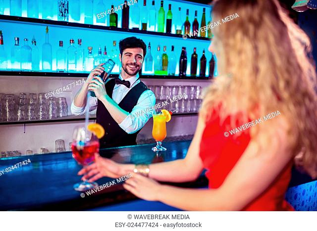 Bartender preparing cocktail for customer