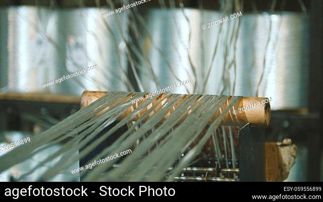 Producing fiberglass rods - manufacture of composite reinforcement, industry for construction, close up