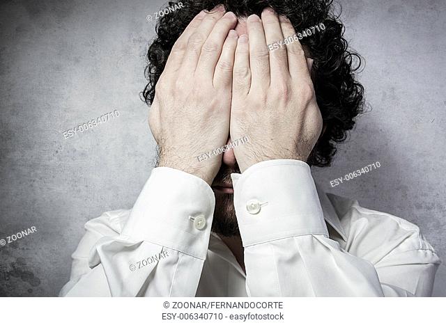Businessman covering his eyes, man in white shirt with funny expressions