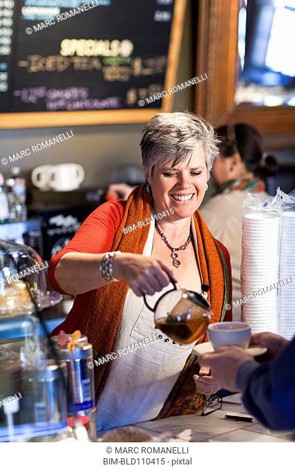Caucasian woman working in coffee shop